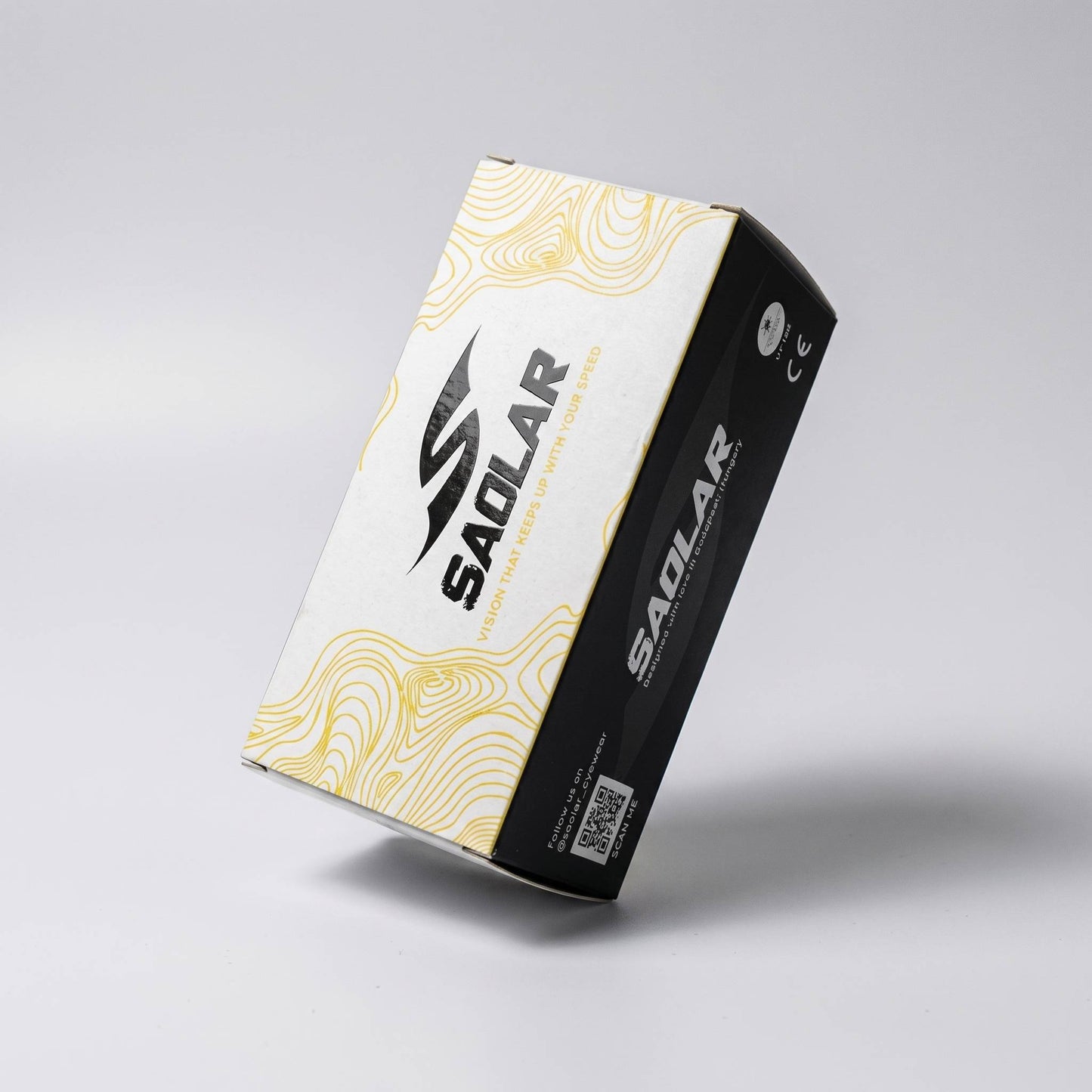 SAOLAR premium sunglasses packaging box in realistic paperboard, featuring clean geometric design, matte finish, and sharp folded edges. High-end carton texture with subtle grain, professional print details, and minimal branding. Modern protective eyewear packaging concept, durable and lightweight, designed for cycling sunglasses with sleek aesthetic and refined product presentation.