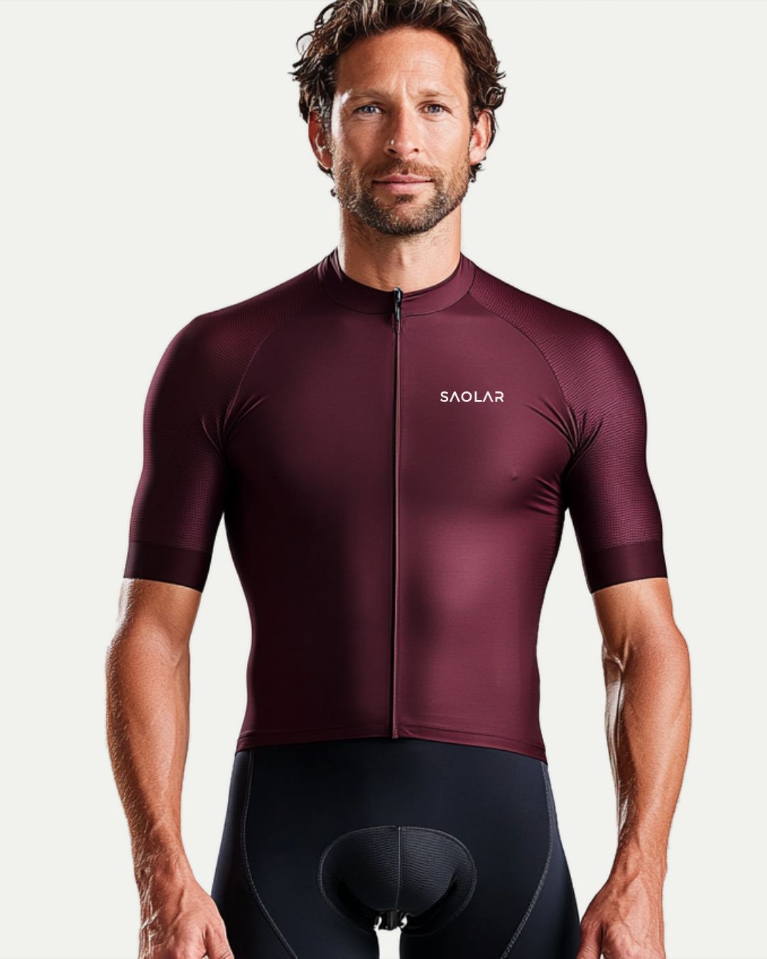 Cyclist wearing SAOLAR burgundy cycling jersey, sleek race-fit design.