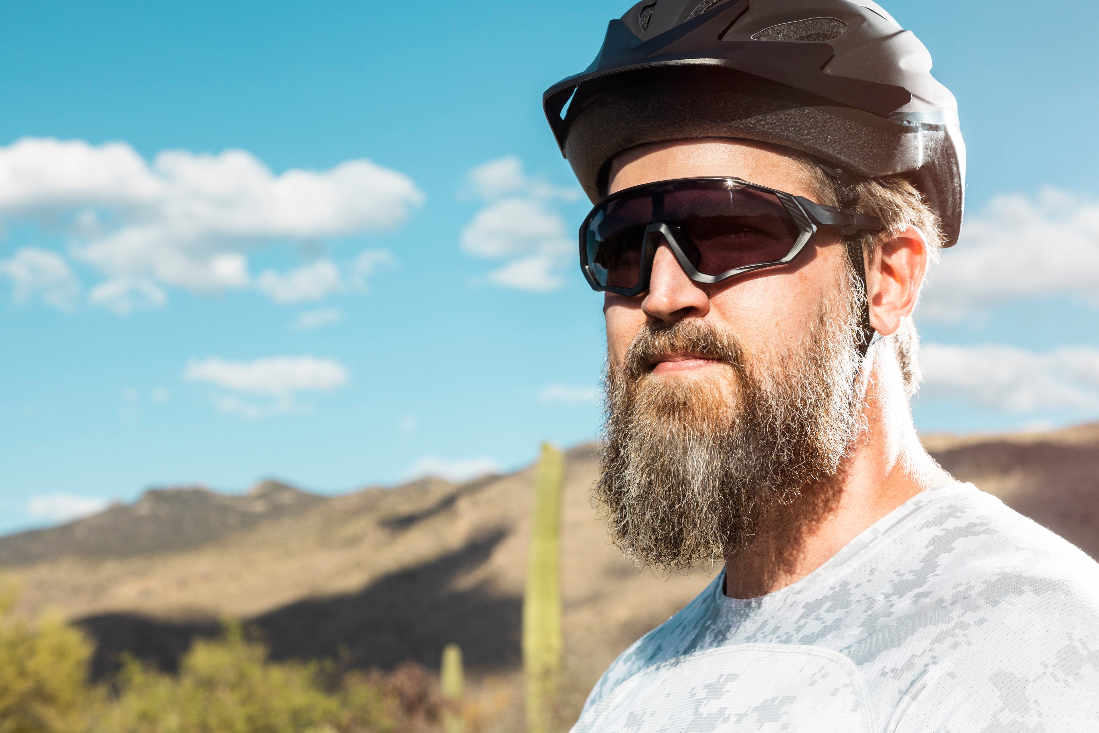 Male in desert wearing SAOLAR biking glasses