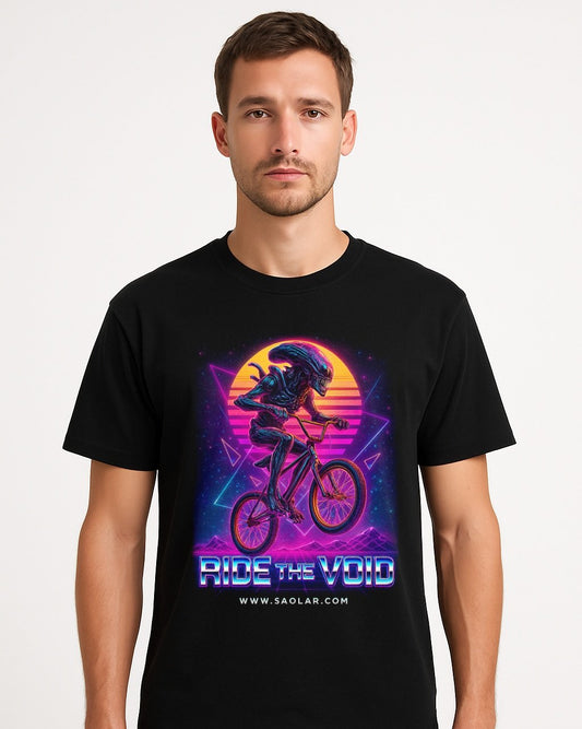 Men’s black t-shirt featuring a retro neon design of an alien riding a BMX bike with glowing synthwave sunset background and the text 'RIDE THE VOID' and 'www.saolar.com