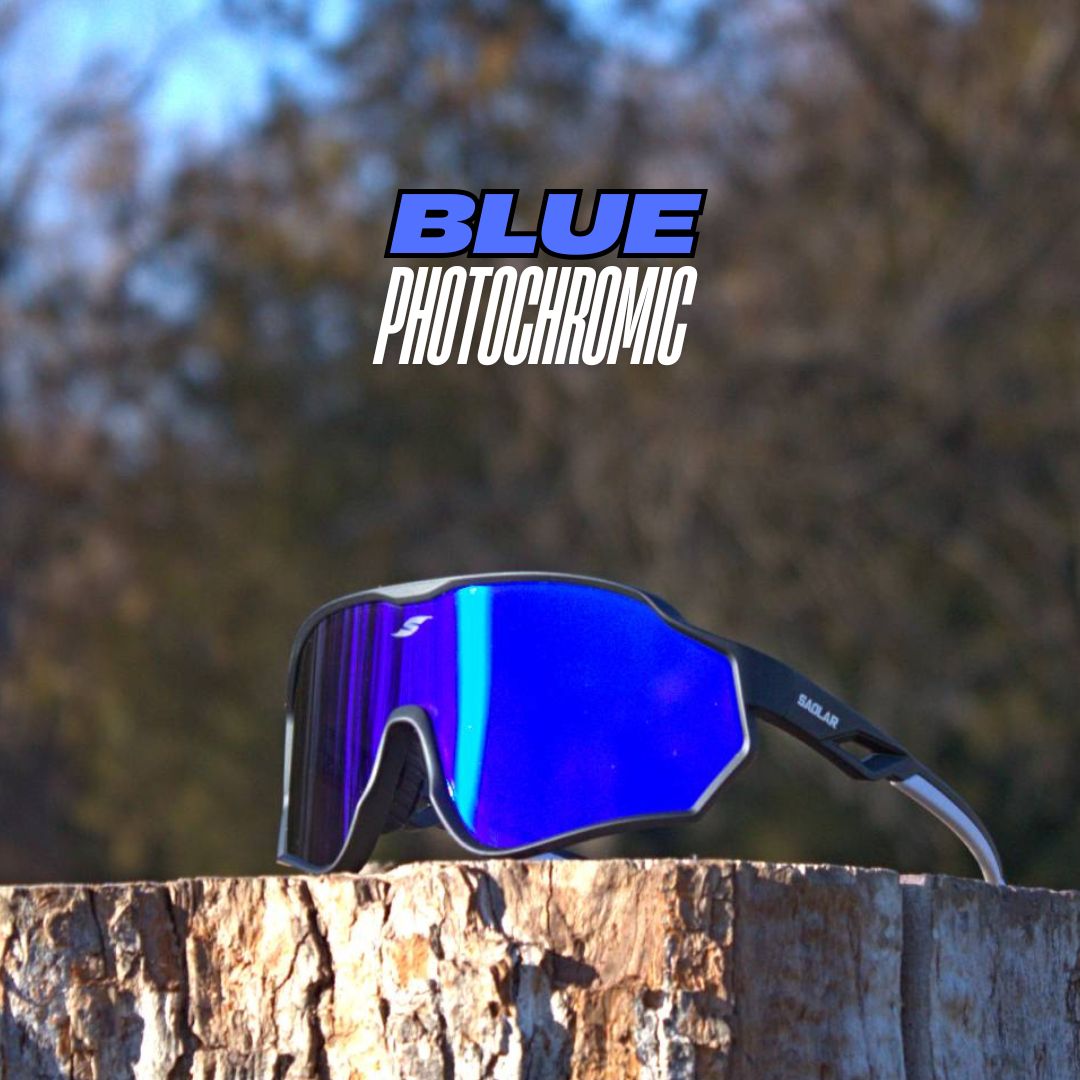 SAOLAR Aquavex blue photochromic sunglasses with a black frame and wraparound lens, placed on a wooden stump in an outdoor setting.