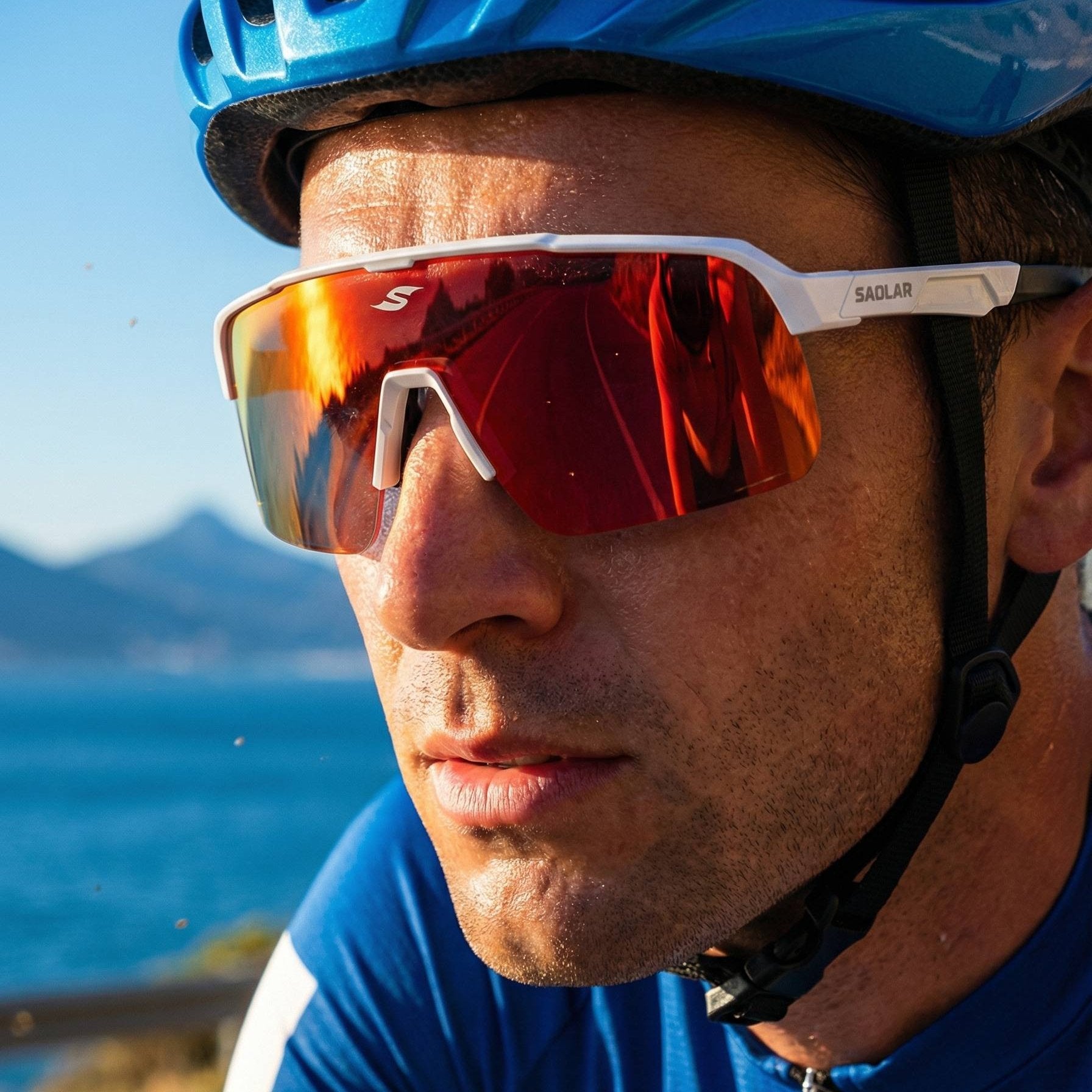 Close-up of a man wearing SAOLAR Flareforce Kingsnake photochromic sports sunglasses with full revo red lenses in bright outdoor sunlight.