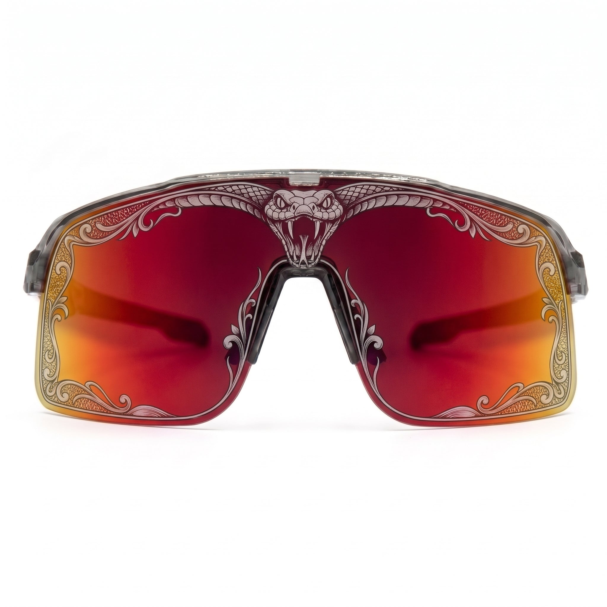 Front view of SAOLAR Flareforce Venom cycling sunglasses featuring a large red-to-orange mirrored shield lens, transparent frame and detailed snake and ornamental laser artwork around the lens edge. These distinctive performance sunglasses combine panoramic vision, wraparound protection and bold design for cycling, running and other outdoor sports.