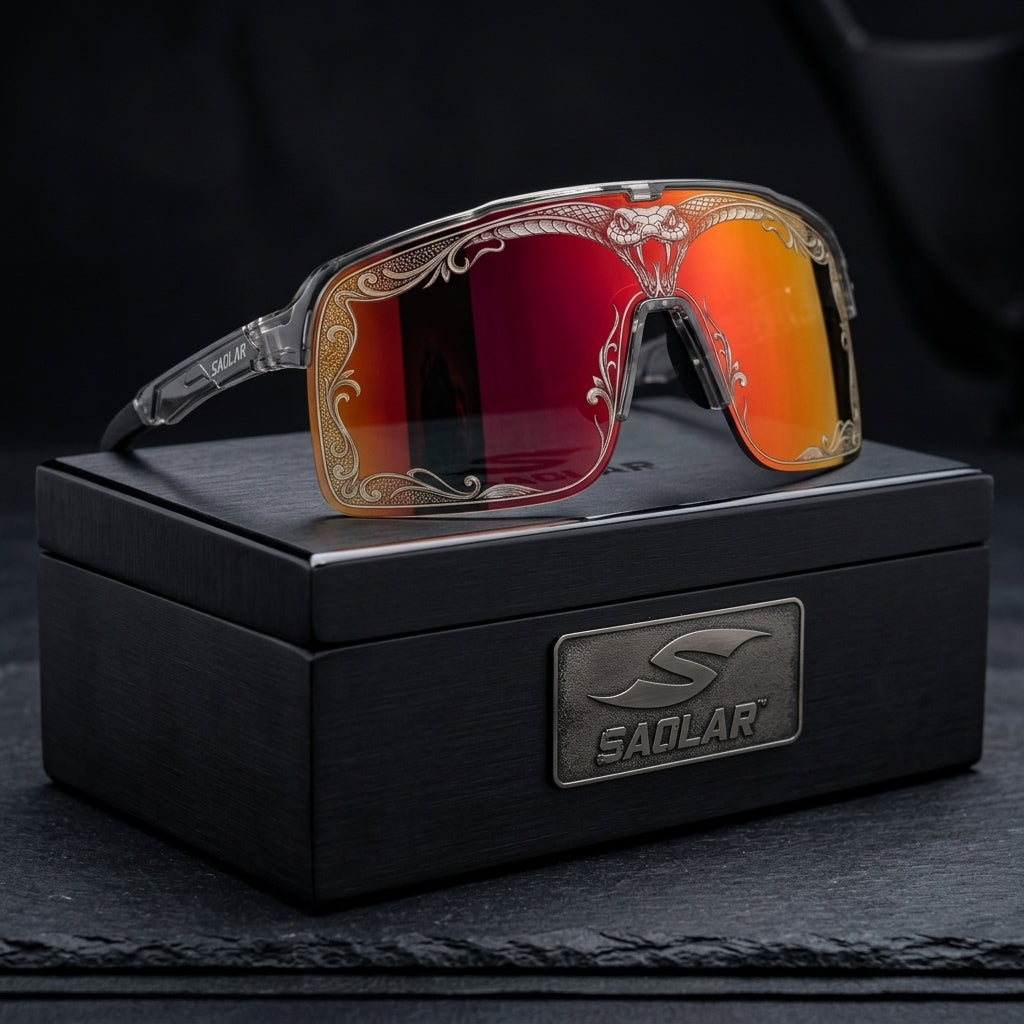SAOLAR Flareforce Venom sports sunglasses featuring a bold red-orange mirrored shield lens, detailed snake-inspired laser engraving and transparent performance frame, displayed on premium black SAOLAR packaging. Designed for cycling and outdoor sports, the Flareforce Venom combines panoramic coverage, distinctive styling and protective wraparound eyewear for active riders.