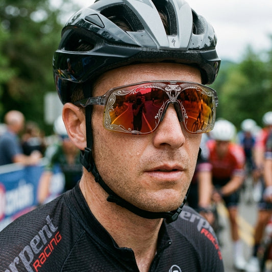 Cyclist wearing SAOLAR Flareforce Venom sunglasses with a red-orange mirrored panoramic lens and intricate venom snake engraving. These wraparound cycling sunglasses offer a striking performance look, broad eye coverage and aerodynamic sport styling, making them ideal for road cycling, gravel riding and outdoor adventures in bright conditions.
