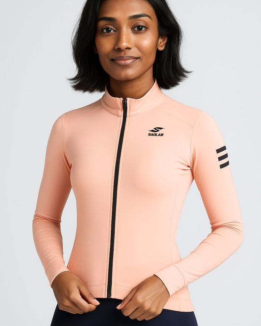 Front view of a woman smiling in the SAOLAR S2 Aurora pink cycling jersey, highlighting its slim fit and black zipper.