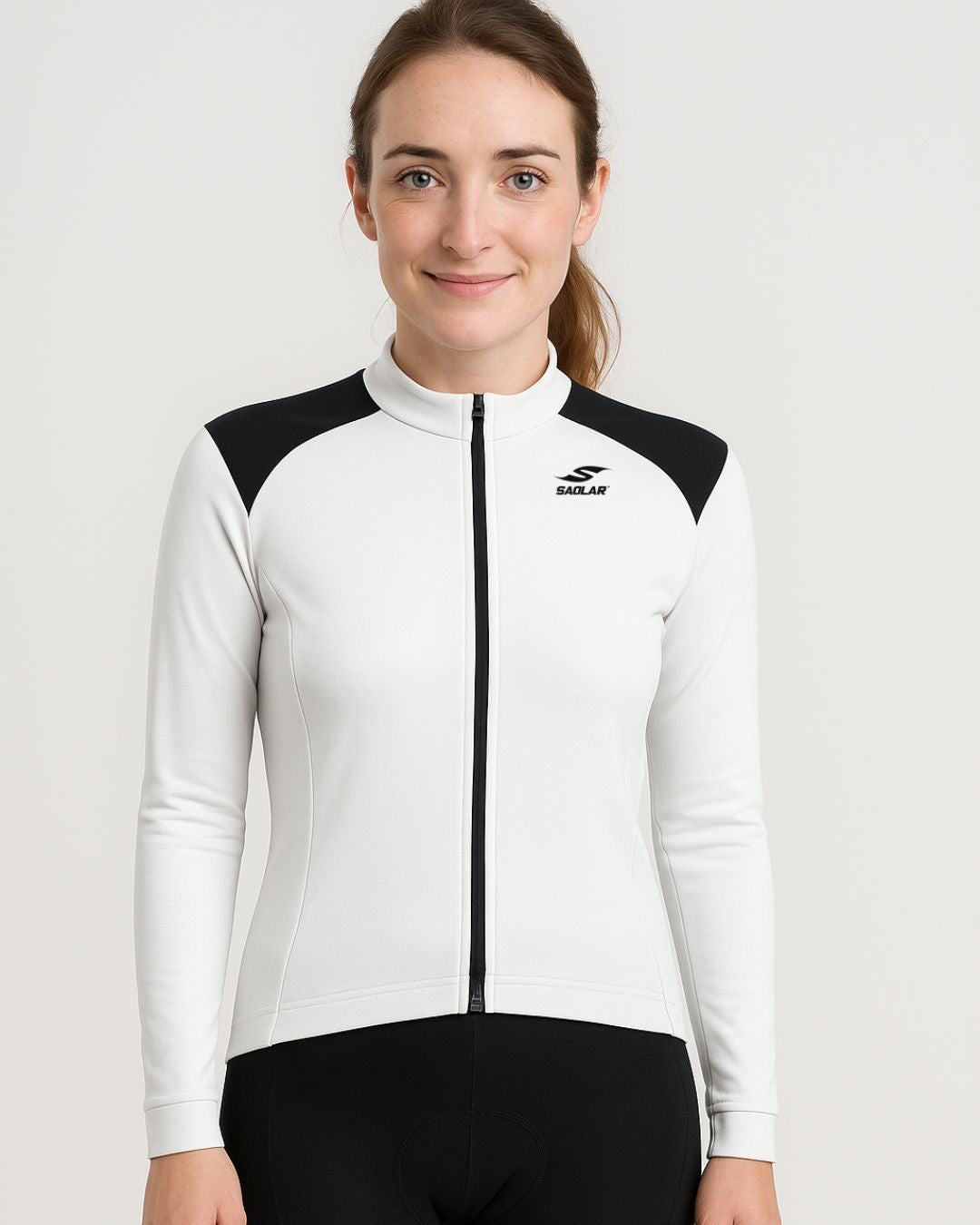 Front view of SAOLAR S4 Lumen women’s long-sleeve cycling jersey in white with black accents, zip closure, and performance-focused design.