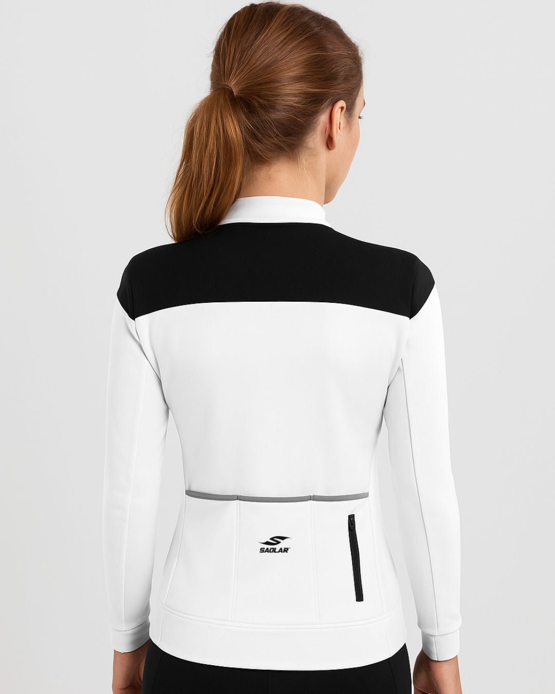 Back view of SAOLAR S4 Lumen women’s cycling jersey in white with black shoulders, long sleeves, rear pockets, and sleek aerodynamic fit.