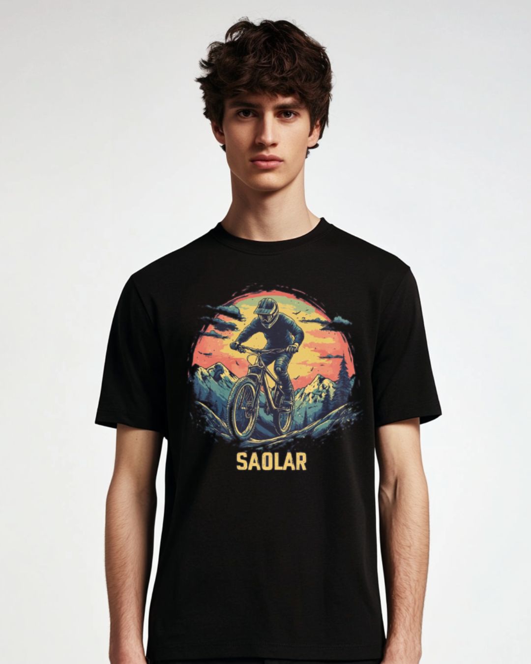 Biker on rugged mountain trail on SAOLAR Apex adventure t-shirt.