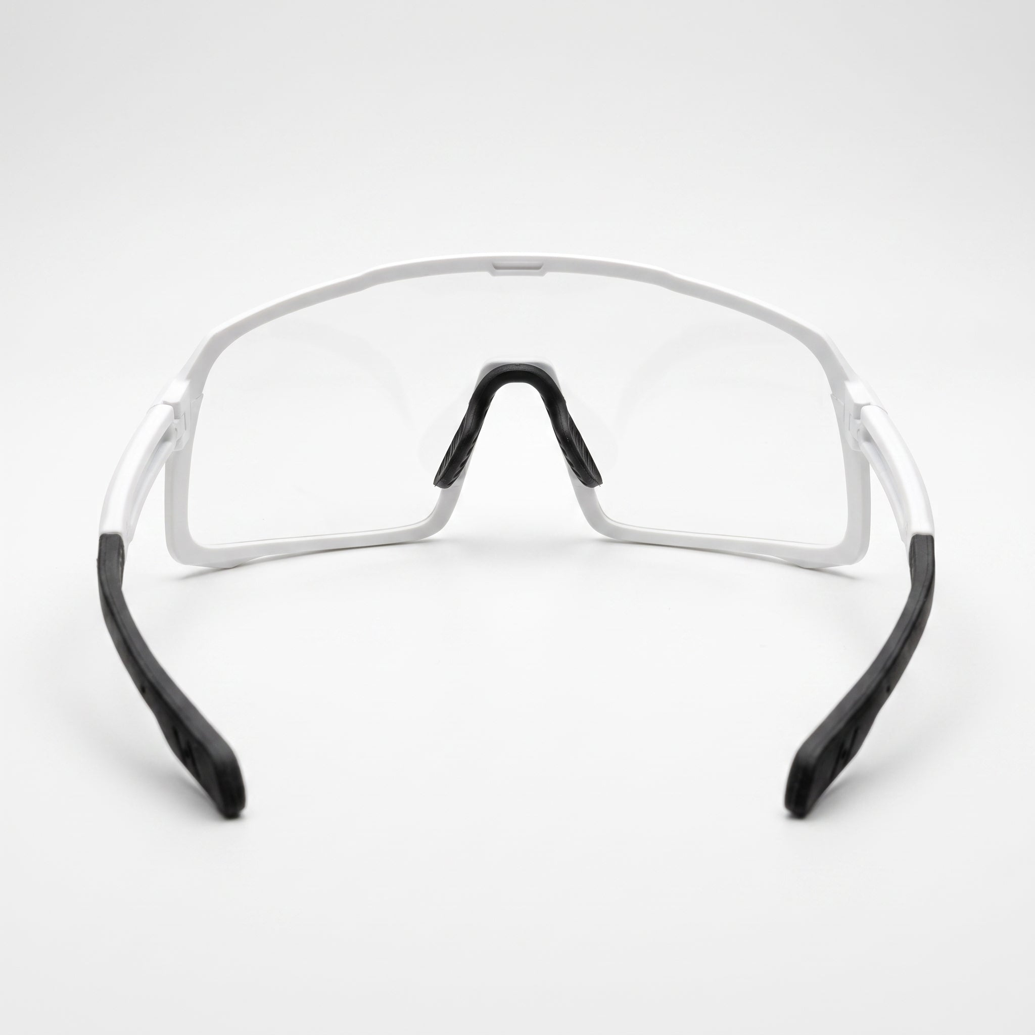 SAOLAR ShadeLane photochromic cycling sunglasses featuring a matte white wraparound frame with a large clear shield lens that automatically adapts to changing light conditions. Front-facing studio product photograph on a clean white background, highlighting the lightweight sports design, adjustable black nose pads, wide field of view, and comfortable rubber temple tips.